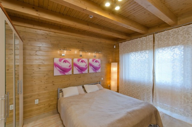 Ložnice v přízemí luxusního srubu