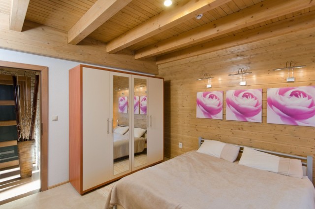 Ložnice v přízemí luxusního srubu